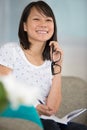 woman holding eyeglasses and writing in journal Royalty Free Stock Photo