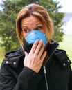 Woman wearing a antiviral face mask to protect from sickness.