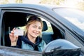 Woman holding her new driving license seated in the car Royalty Free Stock Photo