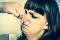 Woman holding her nose - bad smell concept - retro style Royalty Free Stock Photo