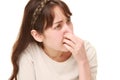 Woman holding her nose because of a bad smell Royalty Free Stock Photo