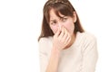 Woman holding her nose because of a bad smell Royalty Free Stock Photo