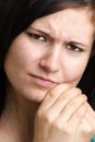 woman holding her painful jawbone