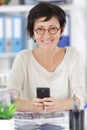 woman holding phone phone in modern office