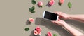 Woman holding her smartphone with pink roses Royalty Free Stock Photo