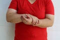 Woman holding her wrist and fingers feeling pain, suffering and numbness. Concept of Guillain barre syndrome and hand numbness aft