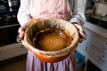 A woman holding a homemade cheesecake