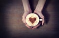 Woman holding hot cup of coffee, with heart shape Royalty Free Stock Photo