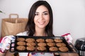 Woman holding hot roasting pan with cookies Royalty Free Stock Photo