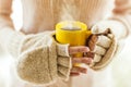 Woman holding hot steaming coffee cup close up photo