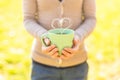 Woman holding hot tea cup with heart shape Royalty Free Stock Photo