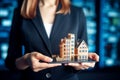 A woman holding house building model in her hands, image for real estate investment business and residential mortgage loan concept Royalty Free Stock Photo