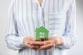 Woman holding house model and coins Royalty Free Stock Photo