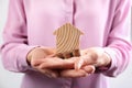 Woman holding house model and coins Royalty Free Stock Photo