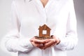 Woman holding house model and coins Royalty Free Stock Photo