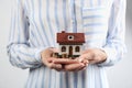 Woman holding house model and coins Royalty Free Stock Photo