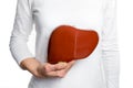 Woman holding human liver model at white body