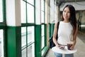 Woman holding iced coffee and looking out of window Royalty Free Stock Photo