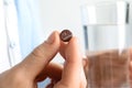 Woman holding iodine pill and glass of water, closeup Royalty Free Stock Photo