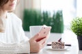 Woman holding iPhone 6 S Rose Gold in cafe