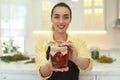 Woman holding jar of pickled vegetables, focus on hands Royalty Free Stock Photo