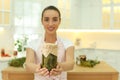 Woman holding jar of pickles in kitchen, focus on hands. Space for text Royalty Free Stock Photo
