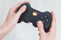A woman is holding a joystick. Gamepad in hands on a white background Royalty Free Stock Photo