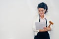 Woman holding judge hammer and document on white background Royalty Free Stock Photo