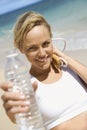 Woman holding jump rope and water bottle. Royalty Free Stock Photo