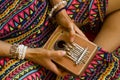 Woman holding kalimba in her hands and playing