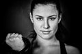 Woman holding a kettlebell and smiling to camera - crossfit fitness