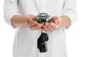 Woman holding key and miniature automobile model on white background, closeup Royalty Free Stock Photo