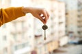 Woman holding key from new apartment over construction background. Real estate concept Royalty Free Stock Photo