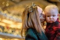 Woman kissing child in church on Christmas Eve Royalty Free Stock Photo