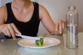 A woman on a weight loss diet with veggies and water. Food portion control Royalty Free Stock Photo