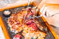 Woman holding knife and fork and slicing a delicious grilled steak Royalty Free Stock Photo