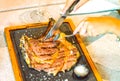 Woman holding knife and fork and slicing a delicious grilled steak Royalty Free Stock Photo