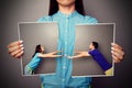 Woman holding the lacerated photo of couple