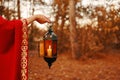 Woman holding a lantern with a candle. Royalty Free Stock Photo