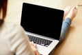 Woman holding laptop with blank screen Royalty Free Stock Photo