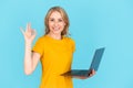 Woman holding laptop computer, showing ok sign Royalty Free Stock Photo