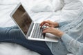 Woman holding laptop with open beauty blogger site on bed Royalty Free Stock Photo