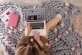 Woman holding laptop with open beauty blogger site on floor Royalty Free Stock Photo