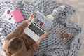 Woman holding laptop with open beauty blogger site on floor Royalty Free Stock Photo