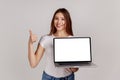 Woman holding laptop with white empty display and showing thumbs up, expressing approval. Royalty Free Stock Photo