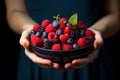 Woman holding large bowl of berries