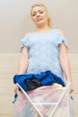 Woman holding laundry basket full of clothes Royalty Free Stock Photo