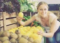 Woman holding lemons in hands in fruit store Royalty Free Stock Photo