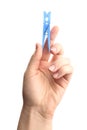 Woman holding light blue plastic clothespin on white background, closeup Royalty Free Stock Photo