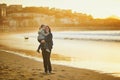 Woman holding little girl on La Concha beach in San Sebastian Donostia, Basque Country, Spain Royalty Free Stock Photo